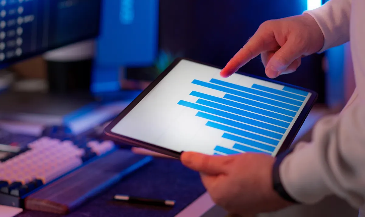 Marketing analyst reviewing a campaign performance chart on a tablet