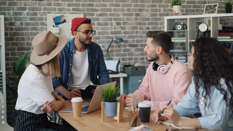 The VividPress team discussing a client's contact-form audit findings in the studio