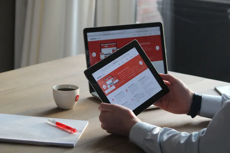 A developer reviewing performance metrics on a tablet before a website launch