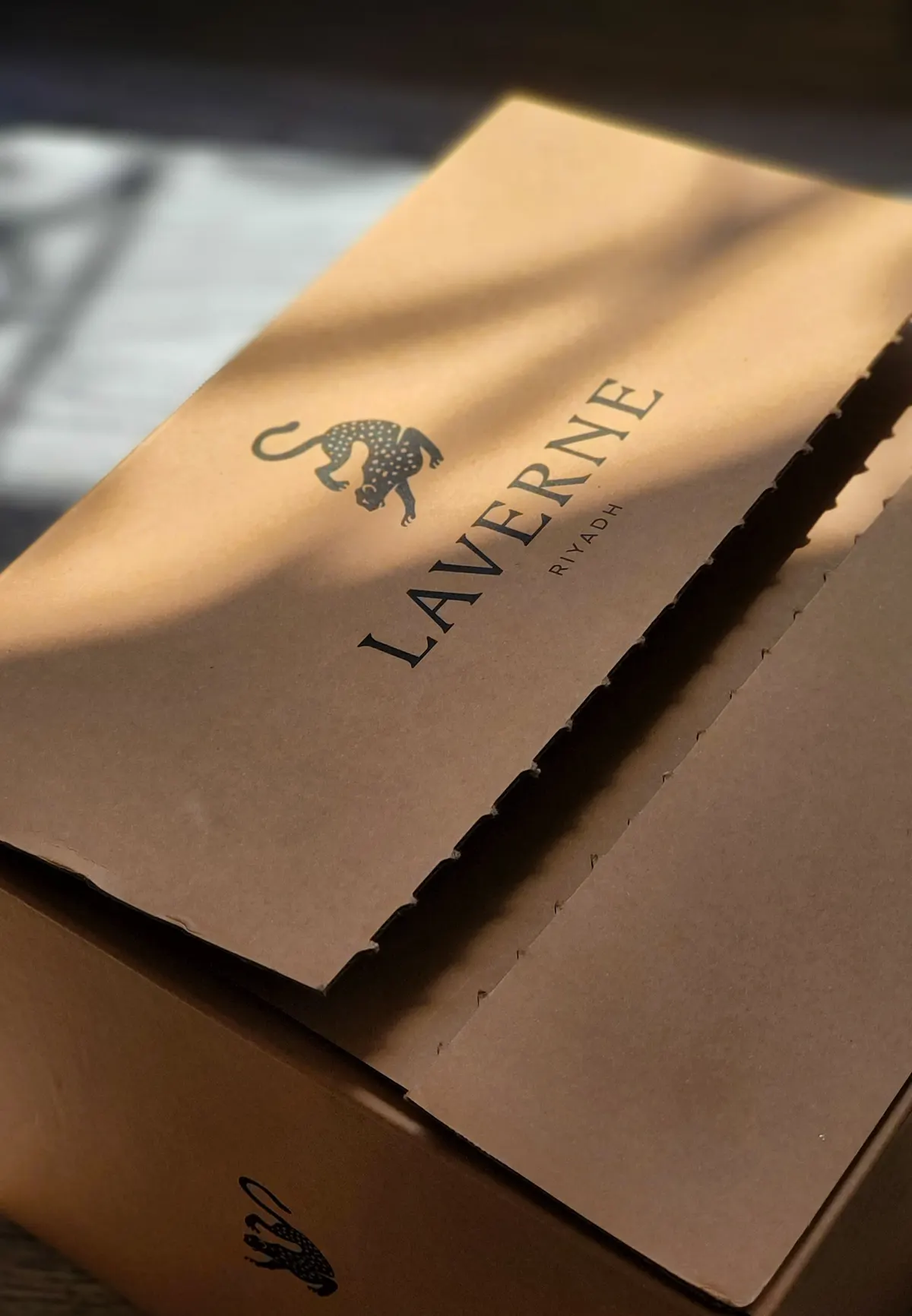 Close-up of a cardboard box printed with an artistic leopard logo