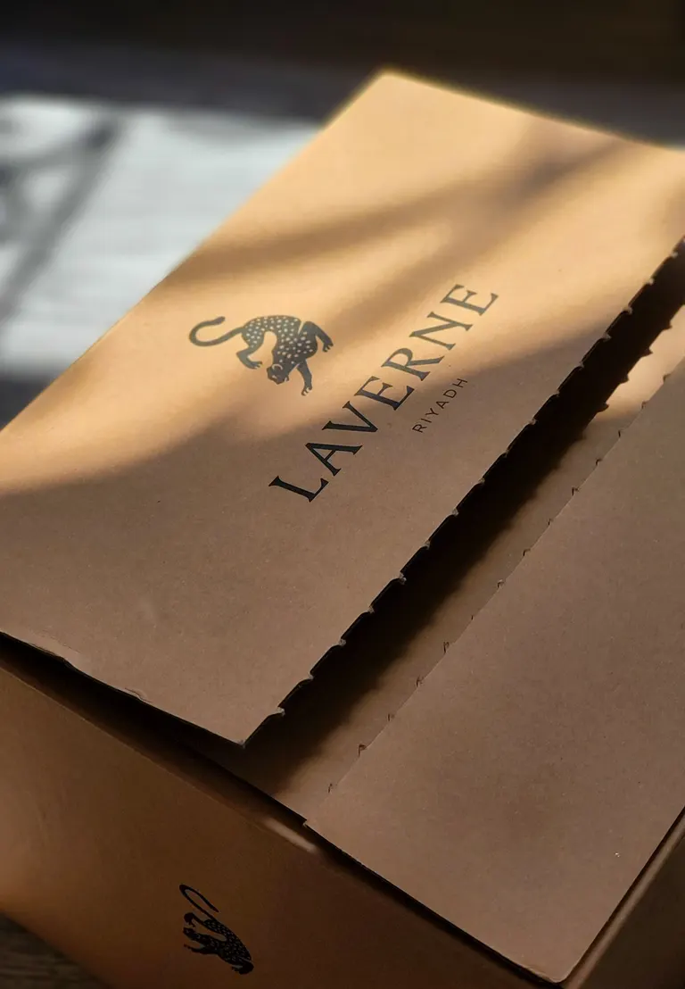 Close-up of a cardboard box printed with an artistic leopard logo